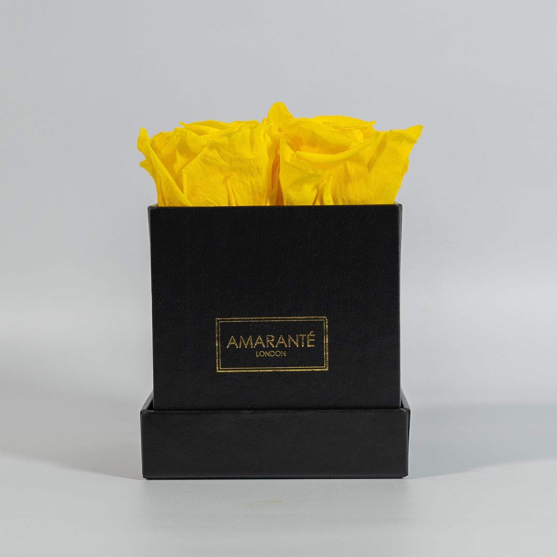 Delightful yellow roses featured in a sleek black box 