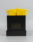Delightful yellow roses featured in a sleek black box 