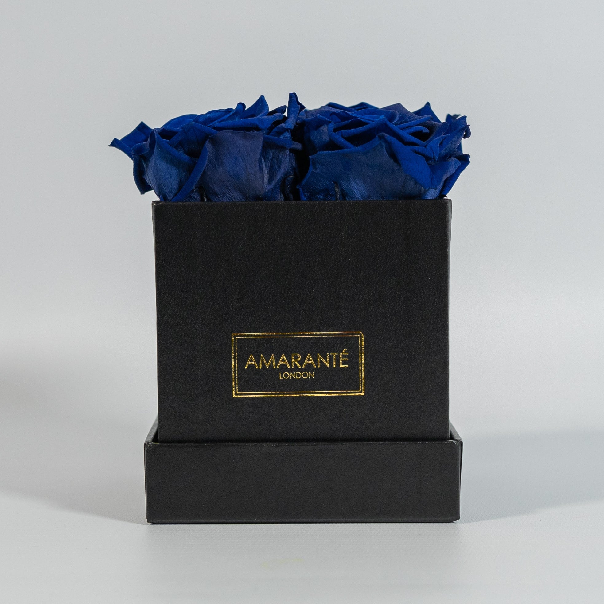 Luxurious royal blue roses featured in a stunning black box 