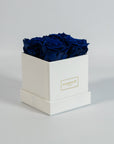 Magical royal blue roses imbedded in a charming white box 