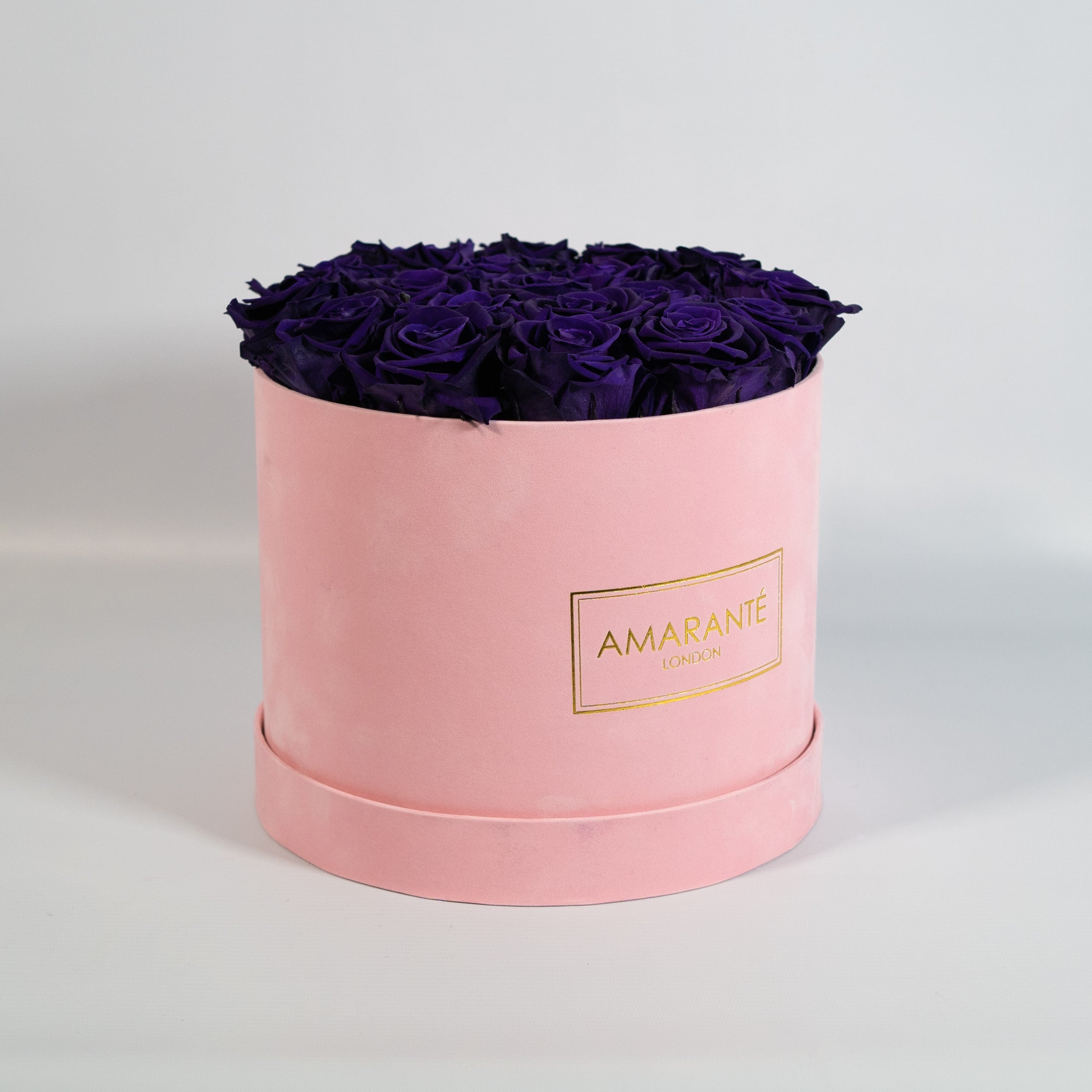 Luxurious dark purple Roses imbedded in a magical pink box 
