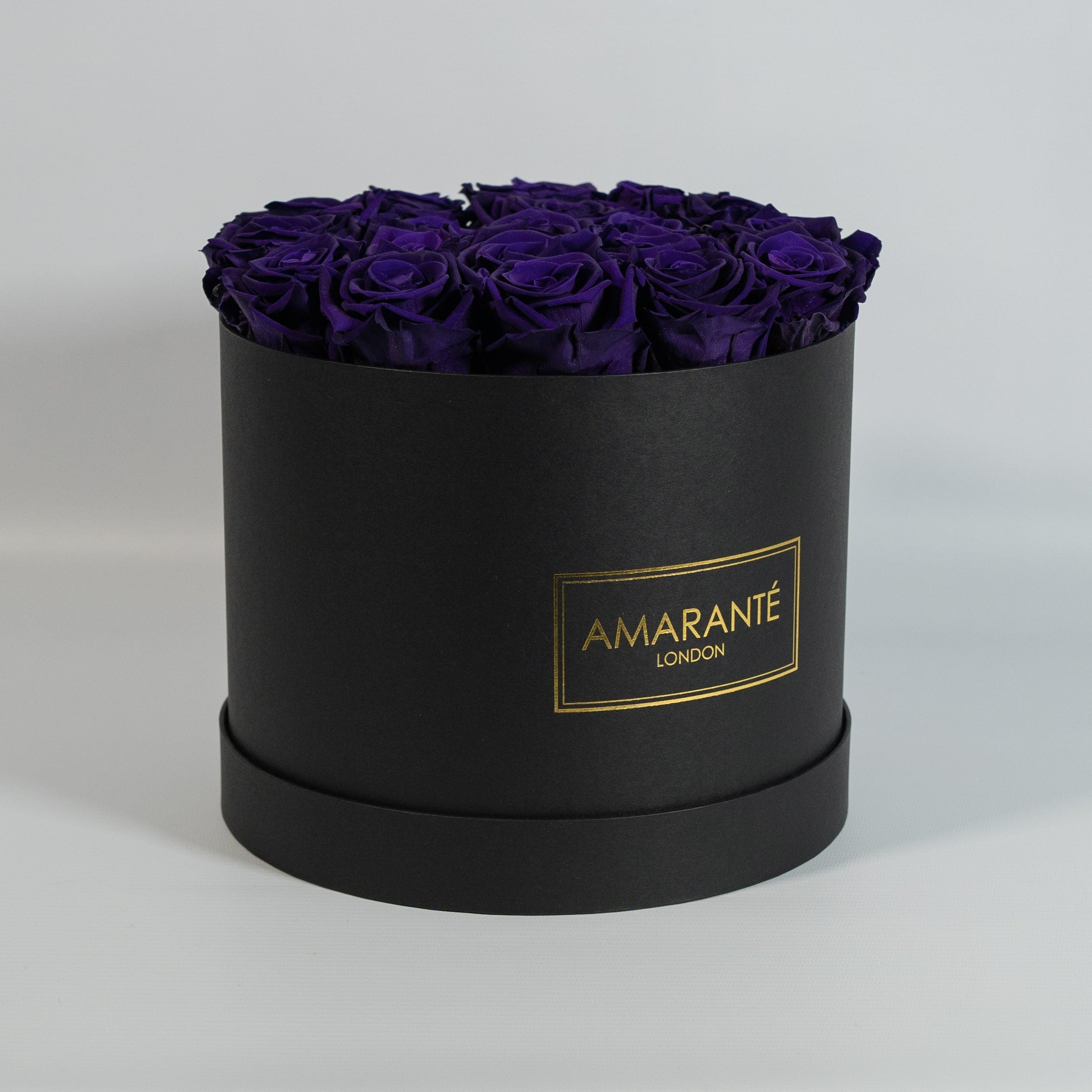 Luxurious dark purple Roses featured in a modish black box
