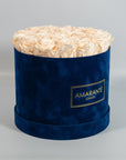 Exciting champagne Roses imbedded in a dapper blue box 