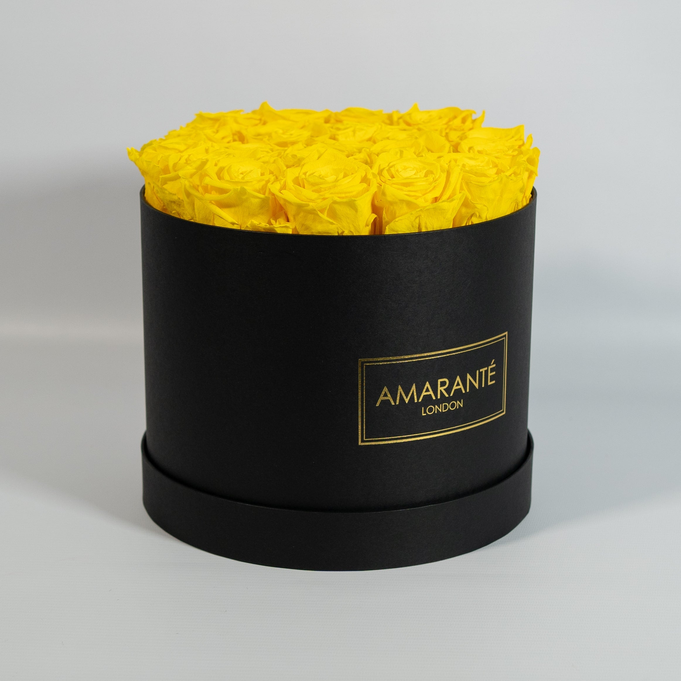 Delightful yellow Roses in an idyllic black box 