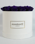 Dapper dark purple Roses comprised in a stunning white large round box 