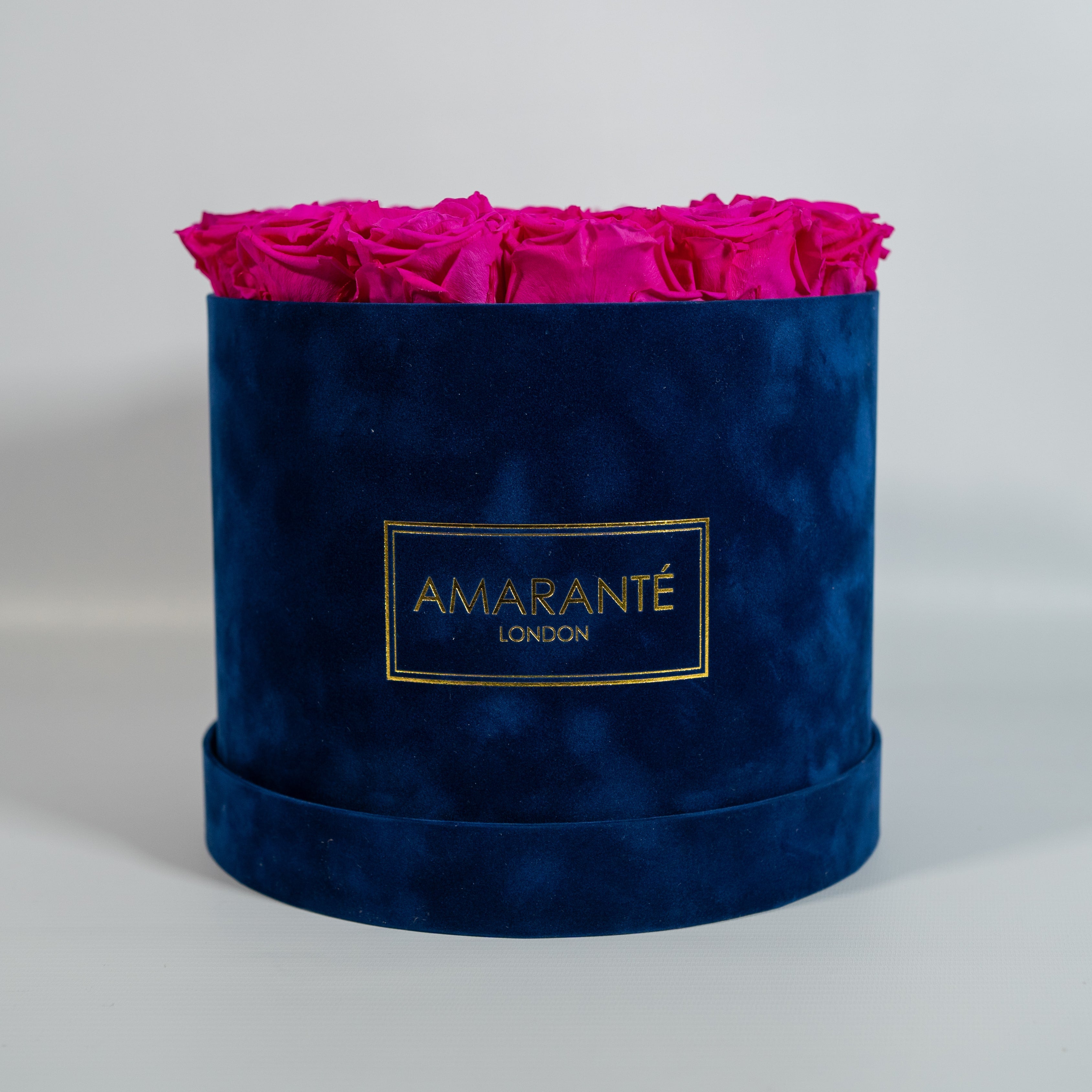 Captivating hot pink Roses featured in a modern blue box 