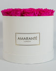 Expressive hot pink Roses featured in a dapper white box 