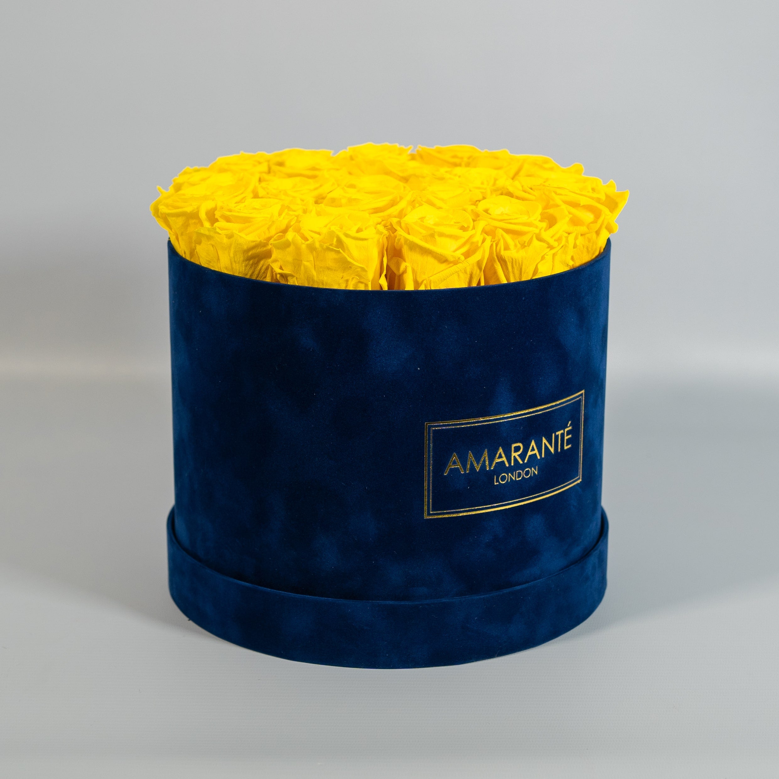 Delightful yellow roses encompassed in a sophisticated blue box 