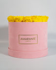 Delightful yellow Roses in a vogueish pink suede box
