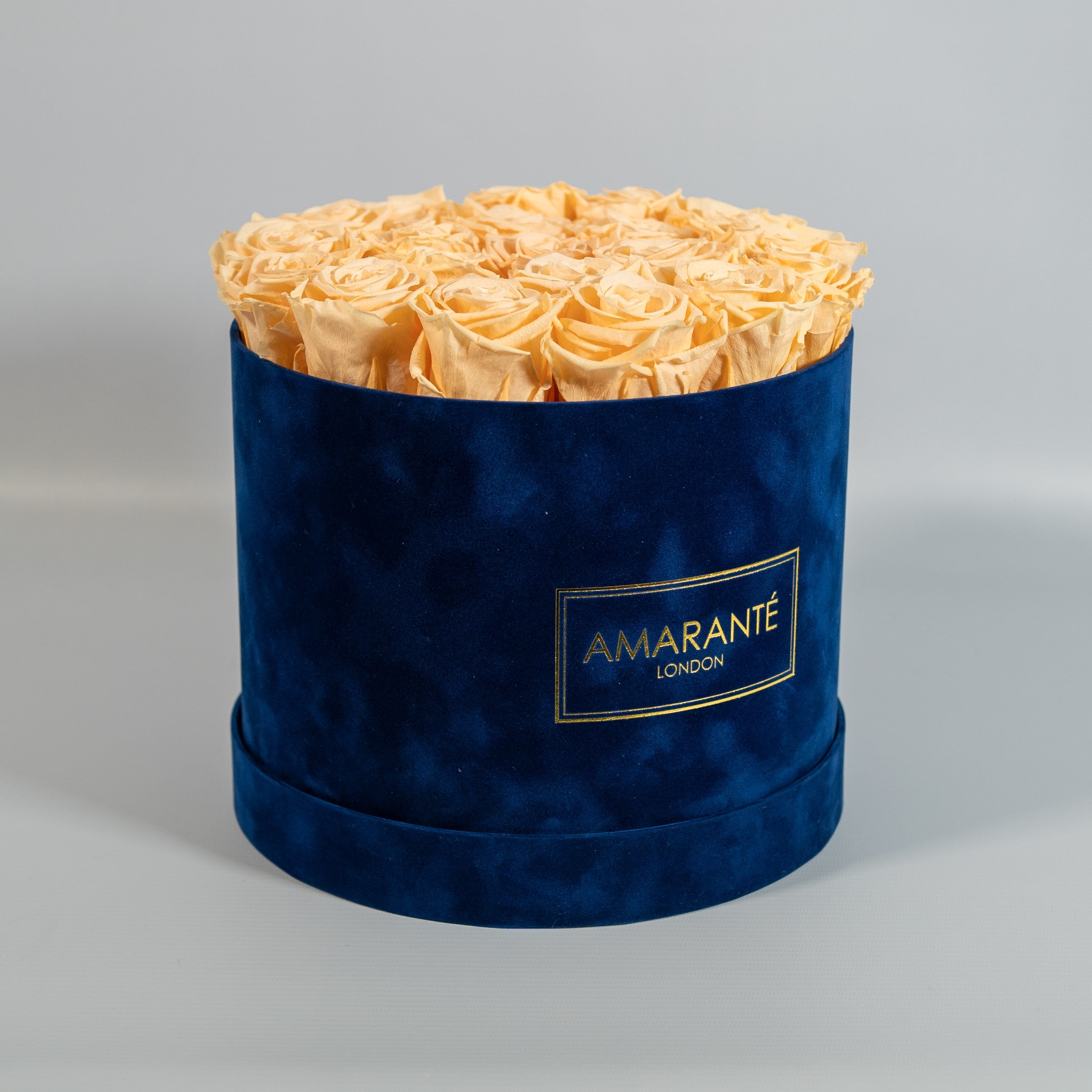 Warm peach Roses included in a magical blue box 