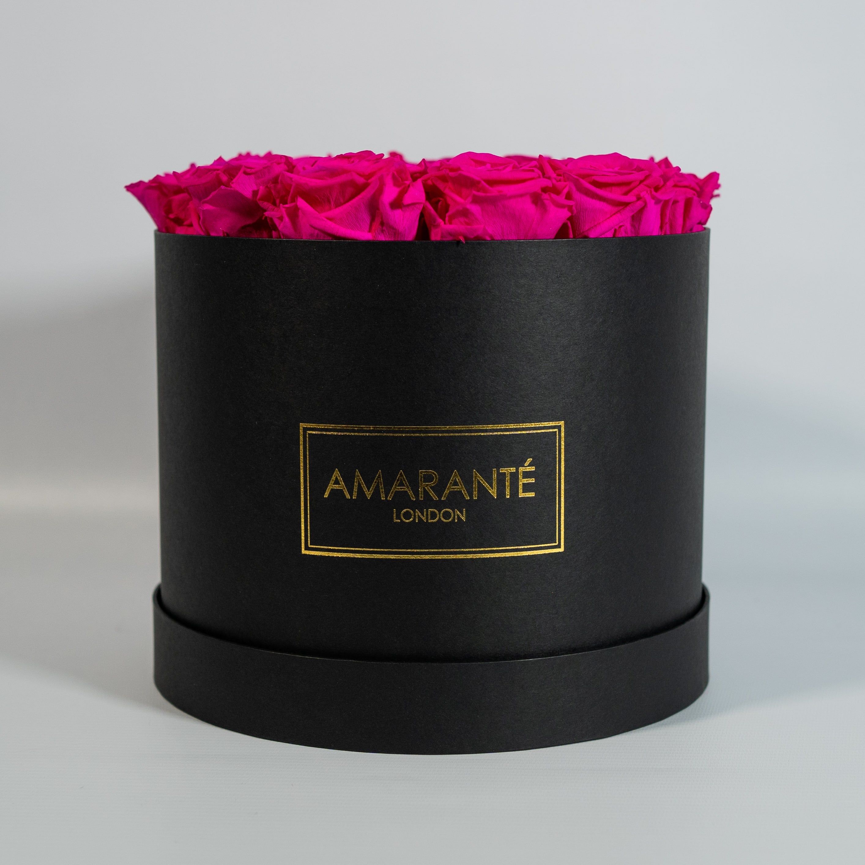 Extravagant hot pink Roses encomapssed in a fashionable black box 