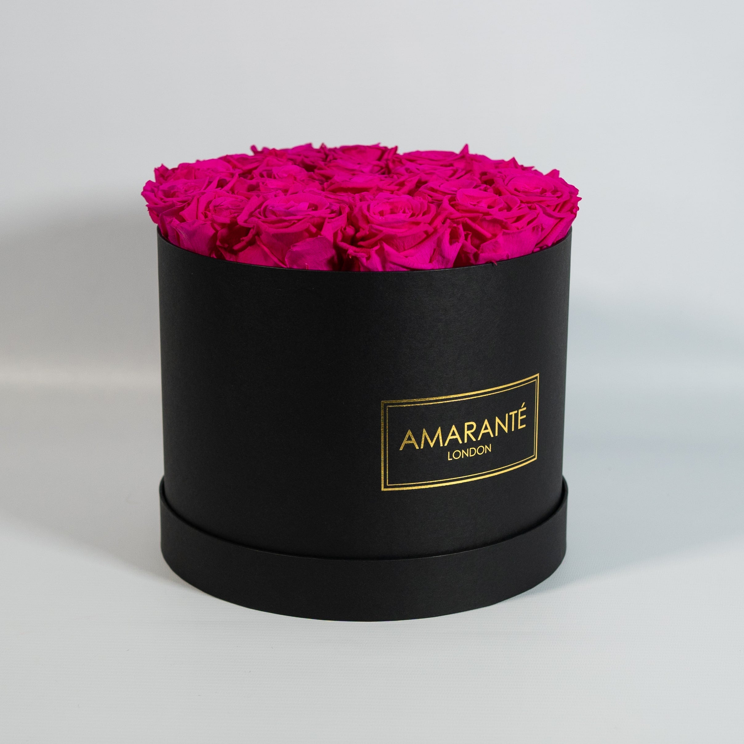 Festive hot pink Roses in a groovy black box 