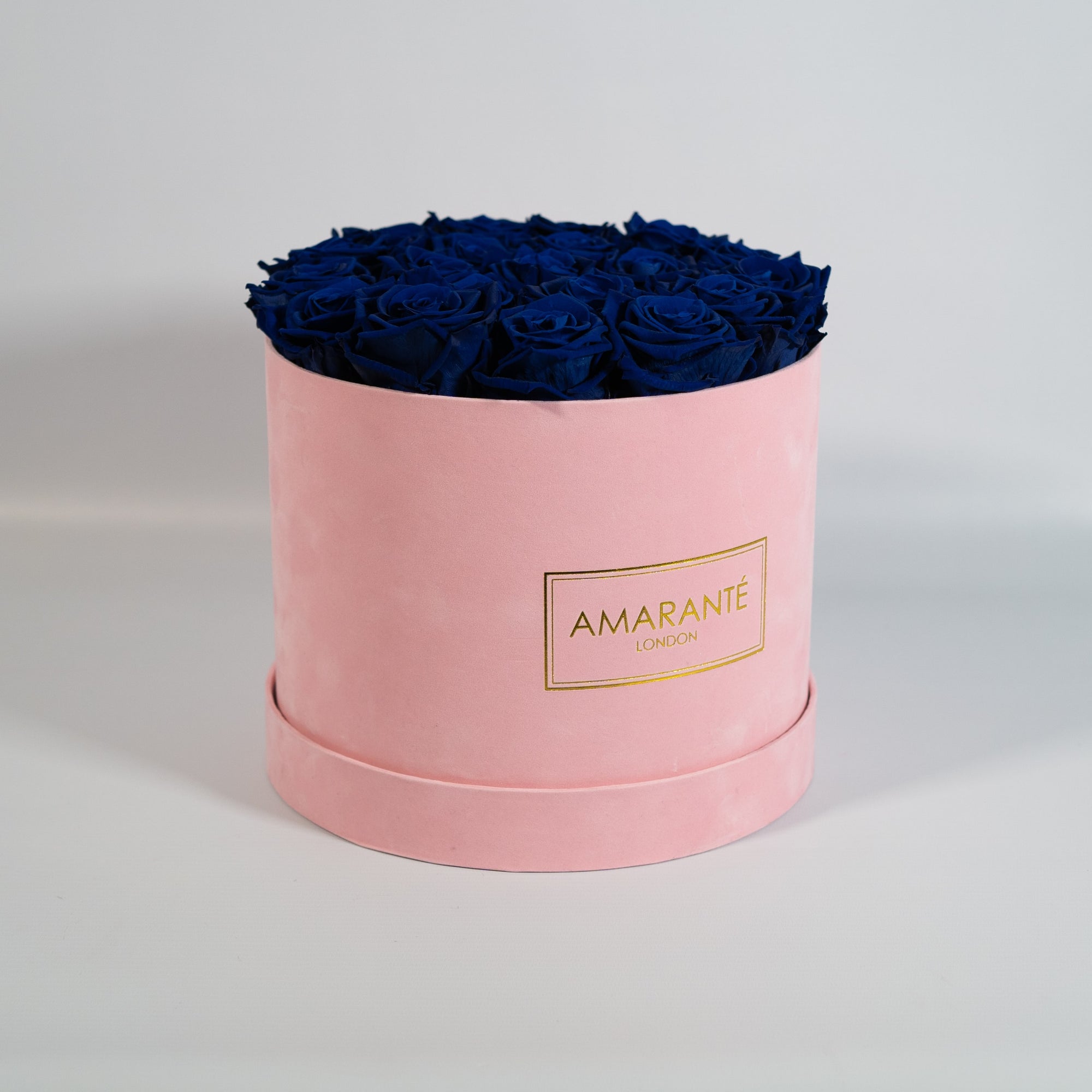 Dapper royal blue Roses in a chic pink box 