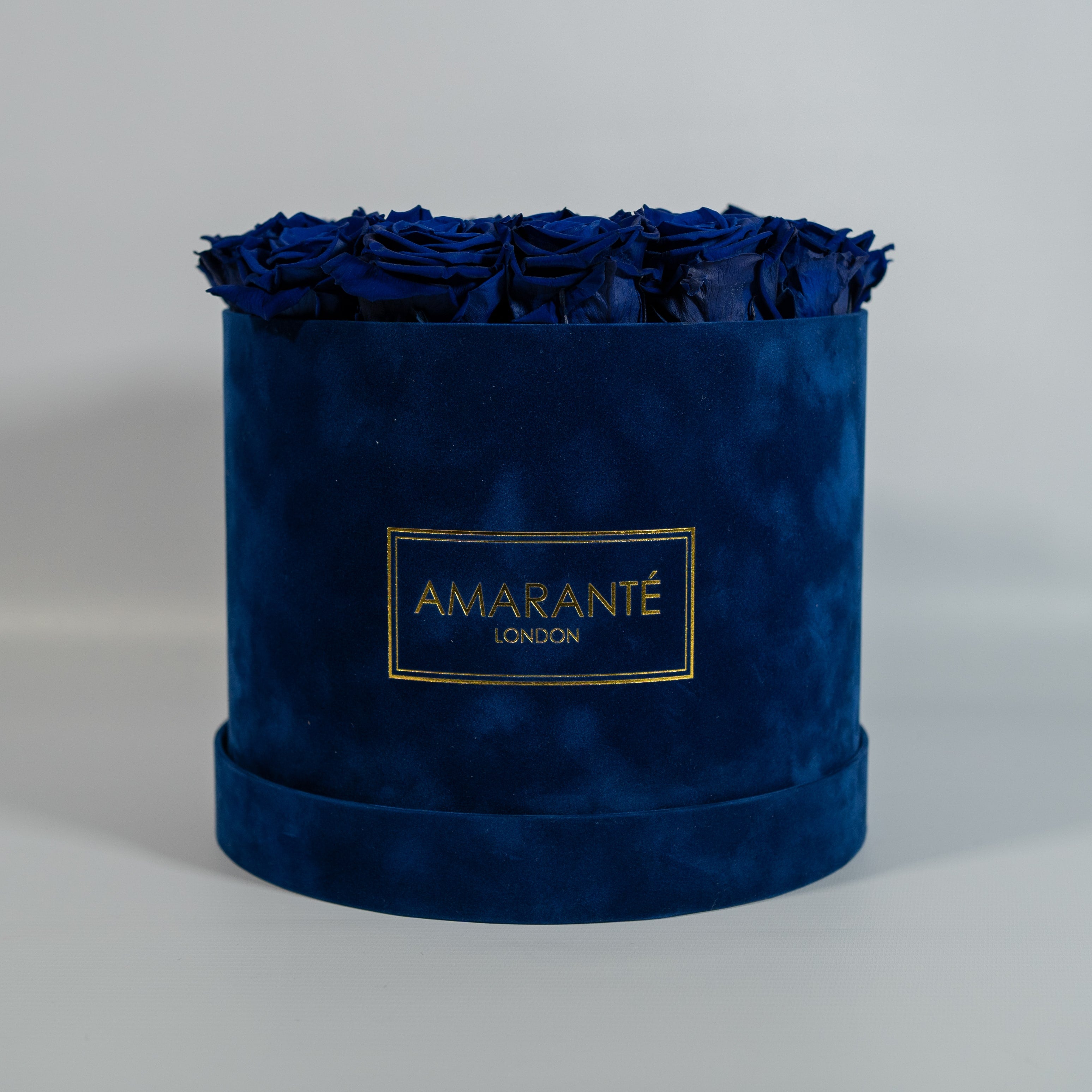 Dapper royal blue roses accessible in a stunning blue box 