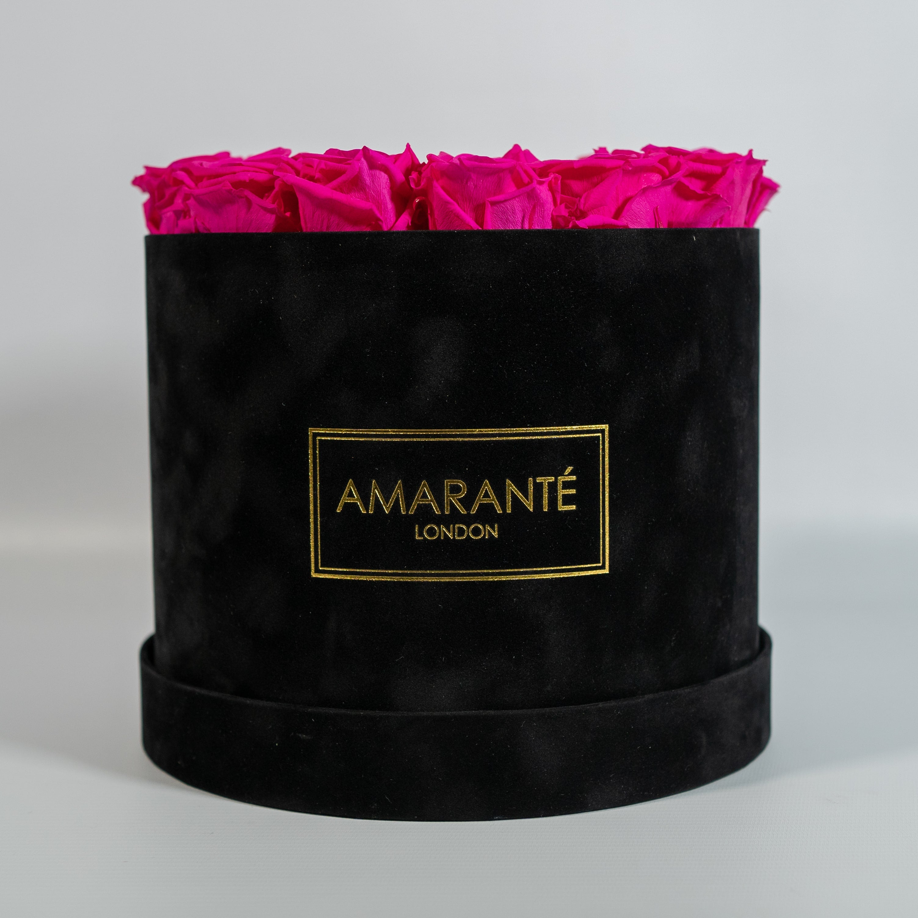 Abloom hot pink Roses in a modish black box 