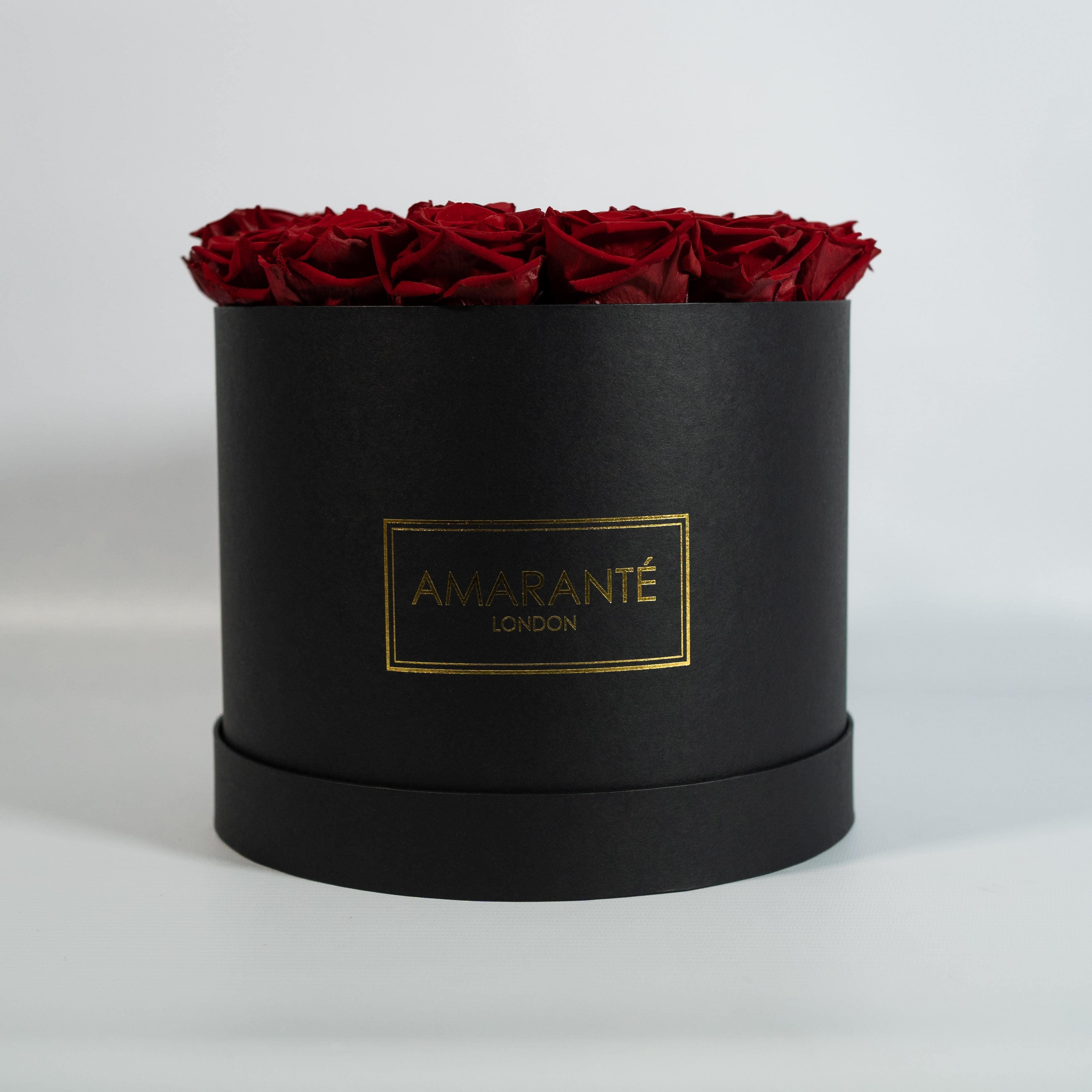 Aromatic wine red Roses featured in a modern black box