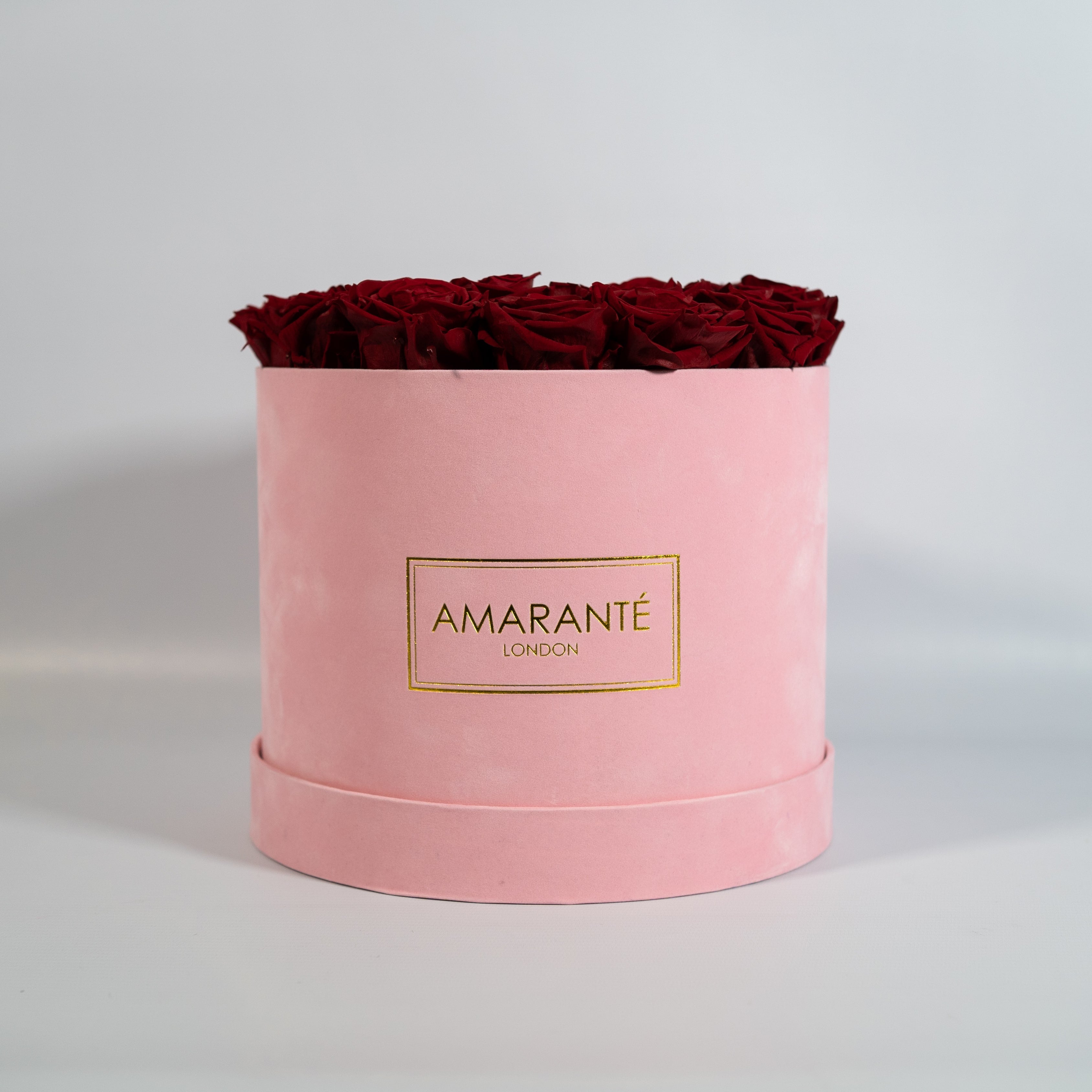 Divine wine Red Roses imbedded in a trendy pink box 