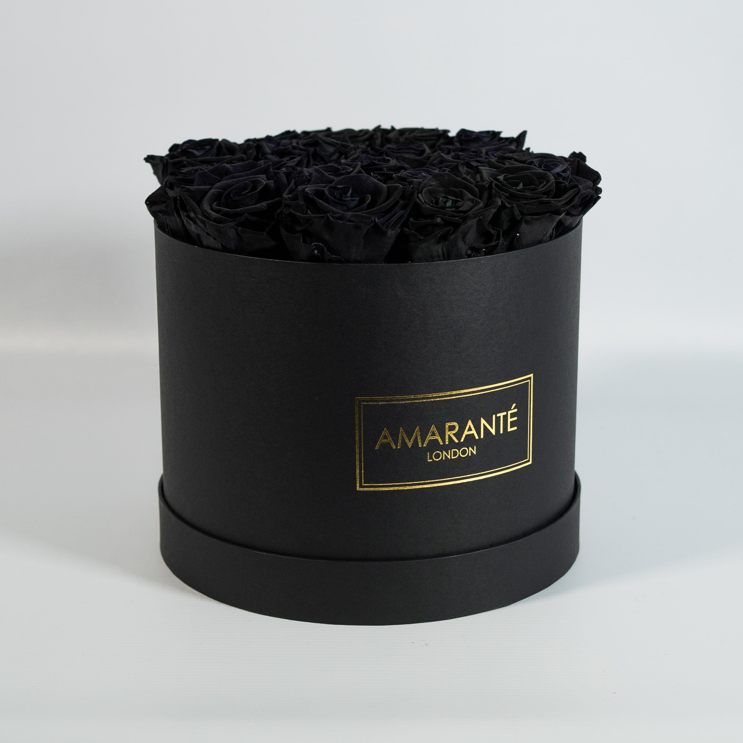 Elegant black Roses in a bold large round hatbox 