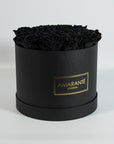 Elegant black Roses in a bold large round hatbox 