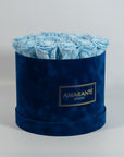 Chic light blue roses imbedded in a gorgeous blue suede box 
