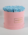 Delicate light blue Roses encompassed in a blushing pink box 