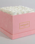 Distinctive white roses featured in a blushing pink box  