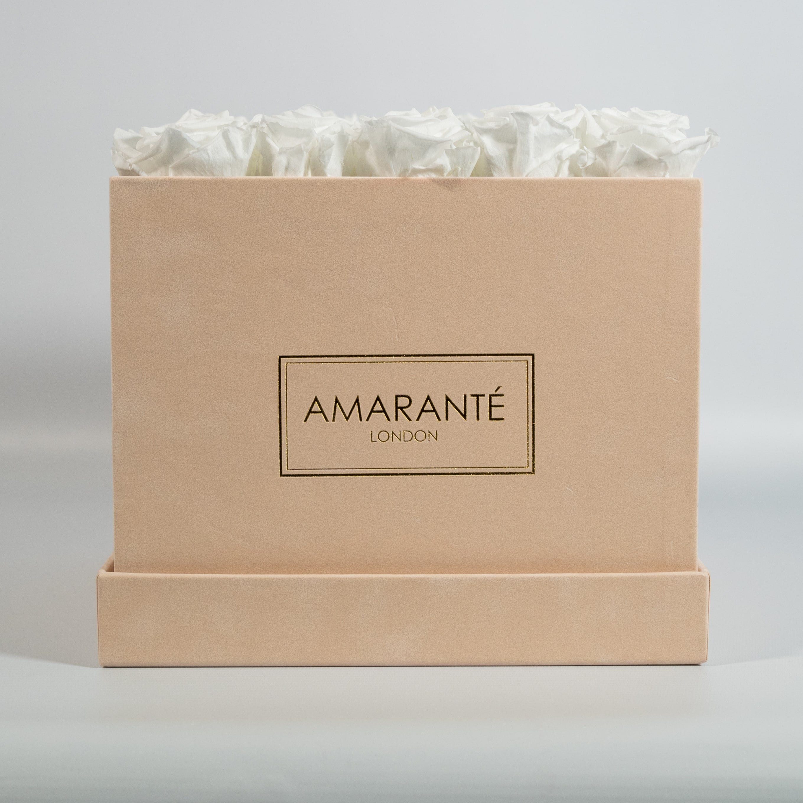 Captivating white Roses in a fashionable beige box.