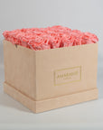 Delicate pink blooms available in an elegant beige box.