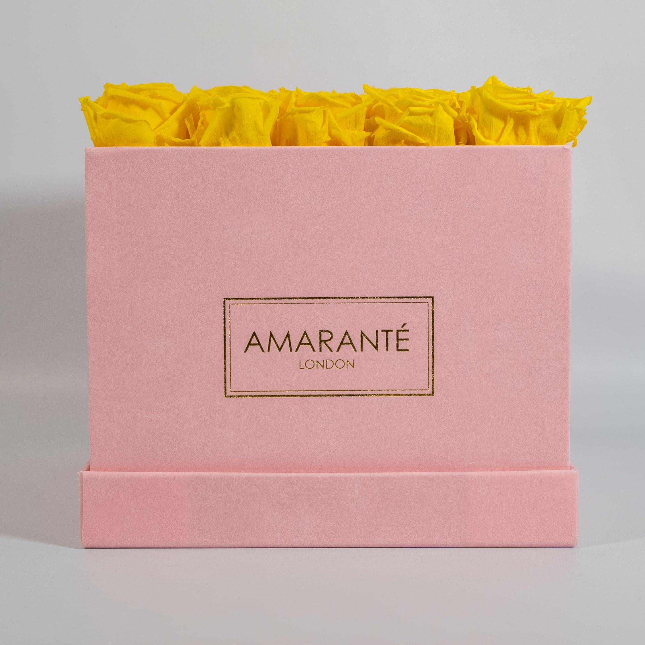 Delightful yellow roses presented in a captivating pink box 