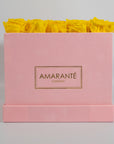 Delightful yellow roses presented in a captivating pink box 