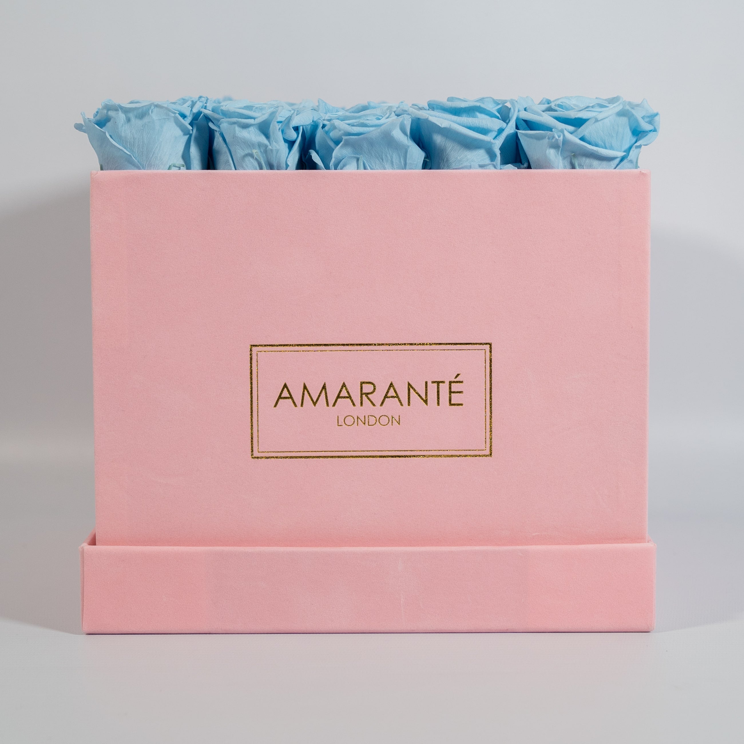 Cool light blue roses featured in a stunning pink box 