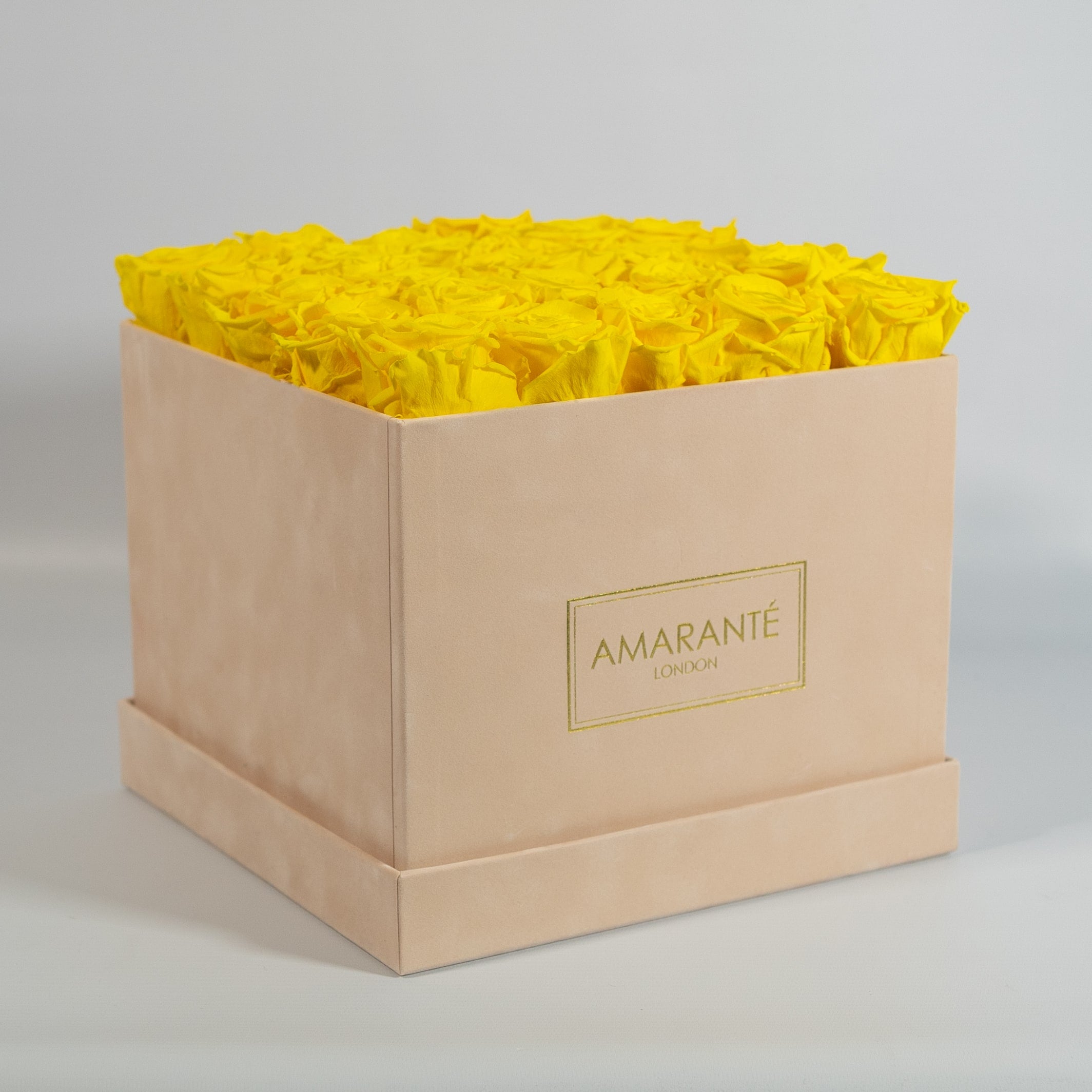 Warm yellow Roses imbedded in a modish beige box.