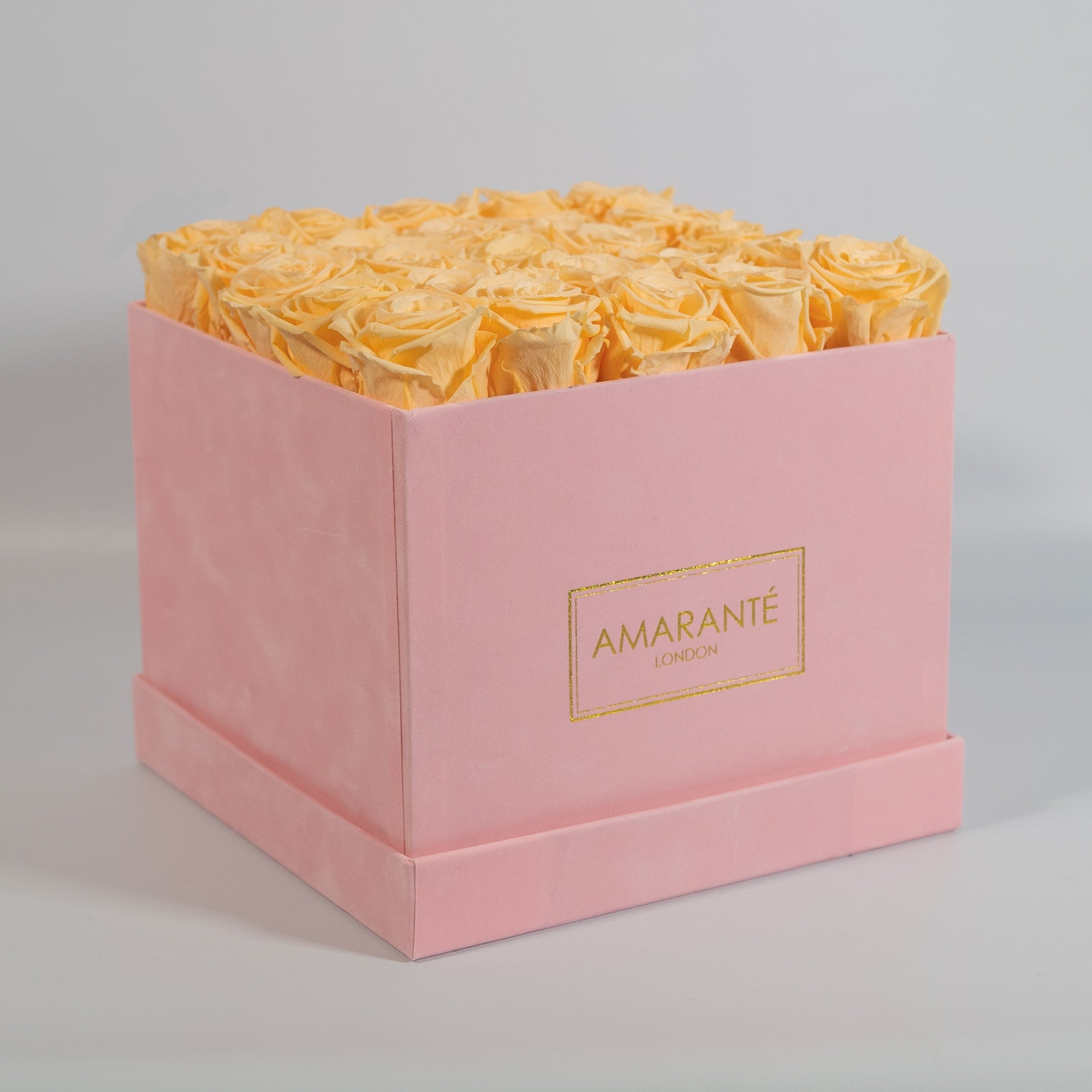 Tranquilising peach roses featured in a dapper pink box 