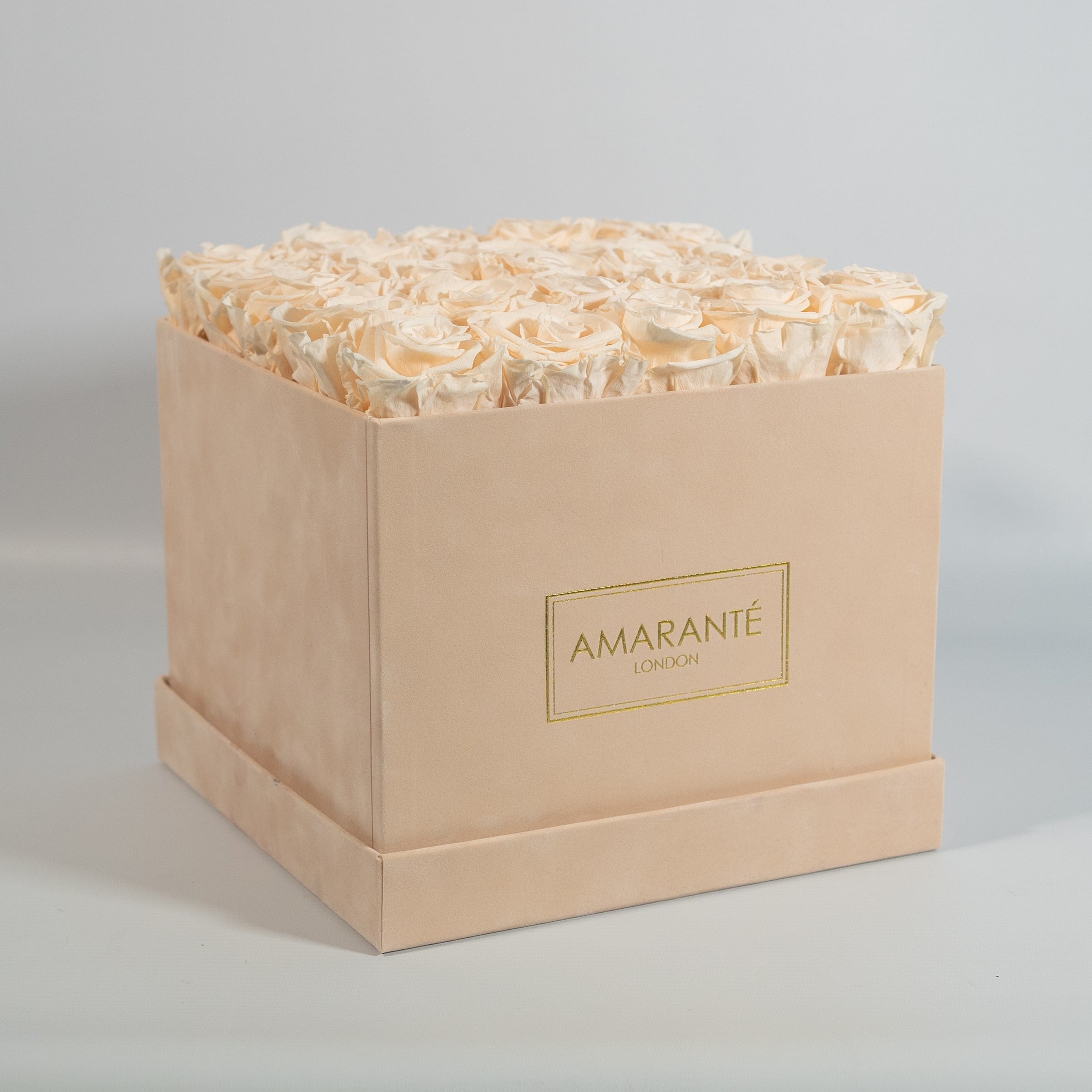 Exciting Champagne Roses in a beautiful beige box.