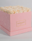 Exciting champagne roses displayed in a modern pink box 