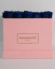 Luxurious royal blue roses featured in a stunning pink box 
