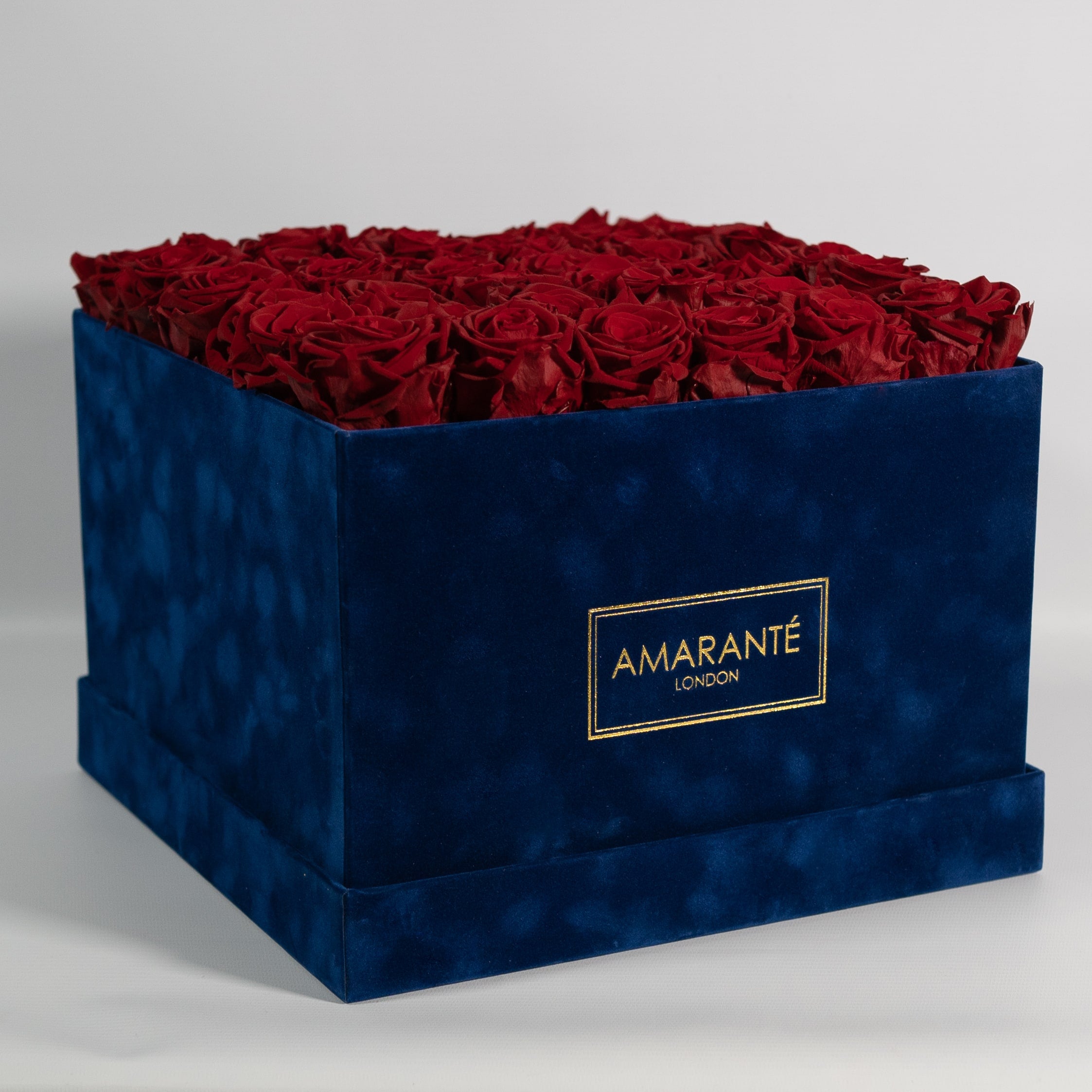 Dapper dark red Roses shown in a divine luxurious blue box, ideal for expressing love, romance, and courage. 