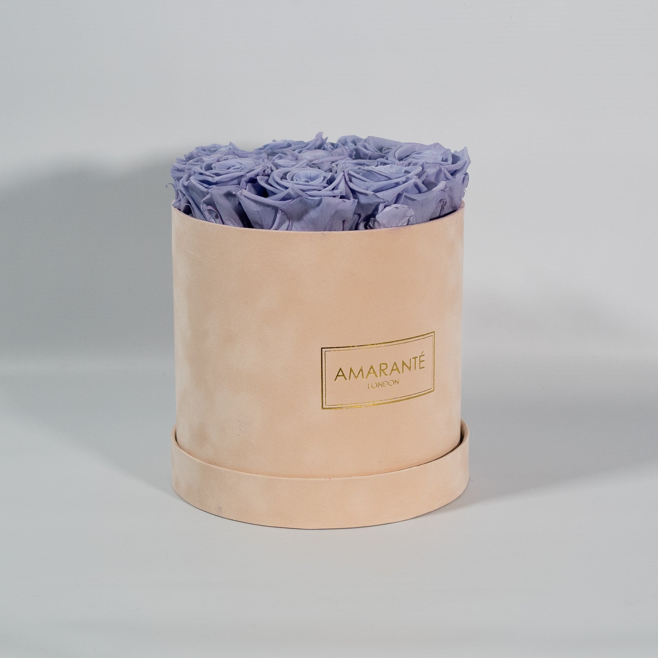Spring inspired lavender roses imbedded in a stylish beige box. 