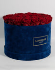 Fragrant dark red roses in a dapper blue package. 