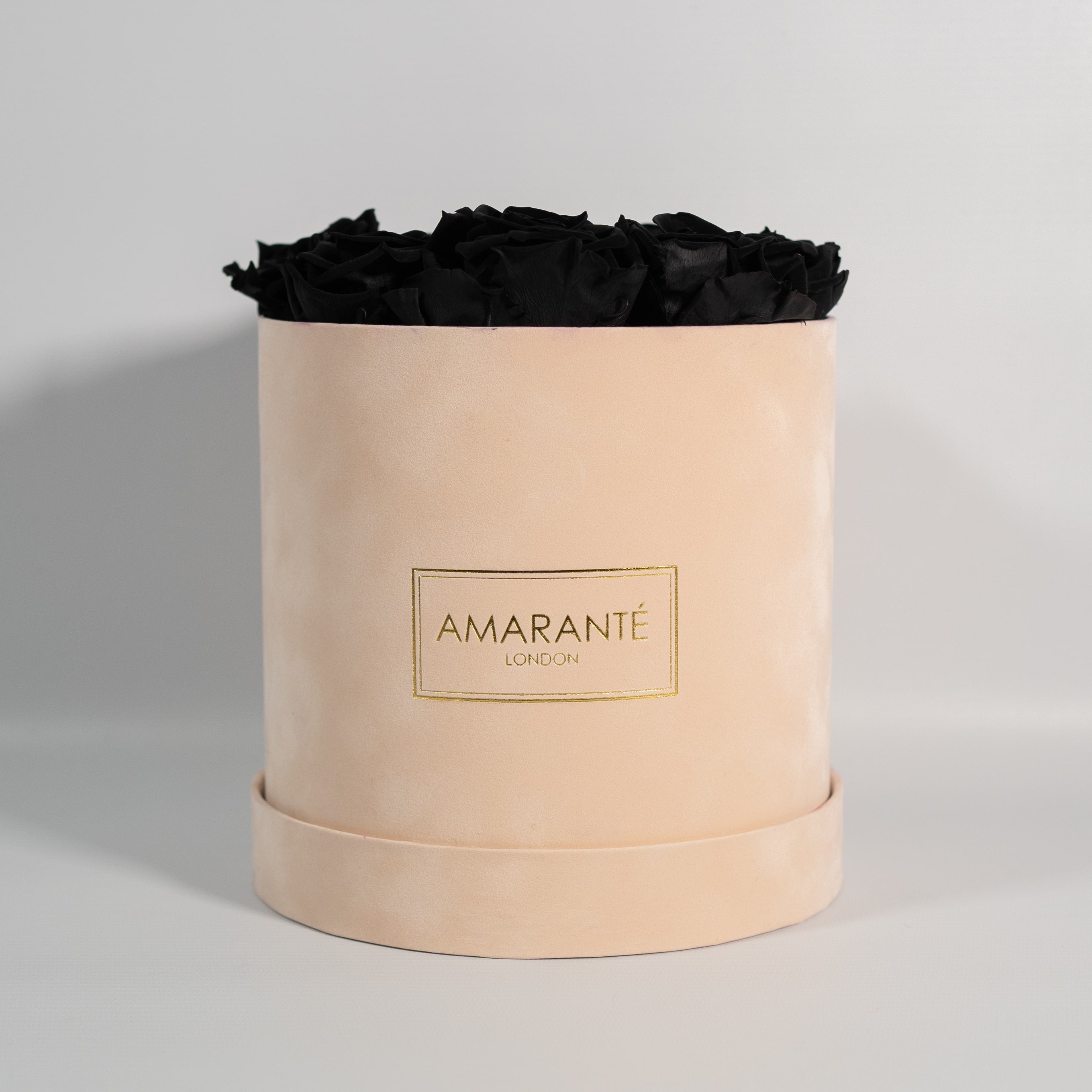 Bold black roses in a captivating beige box in large and suede. 