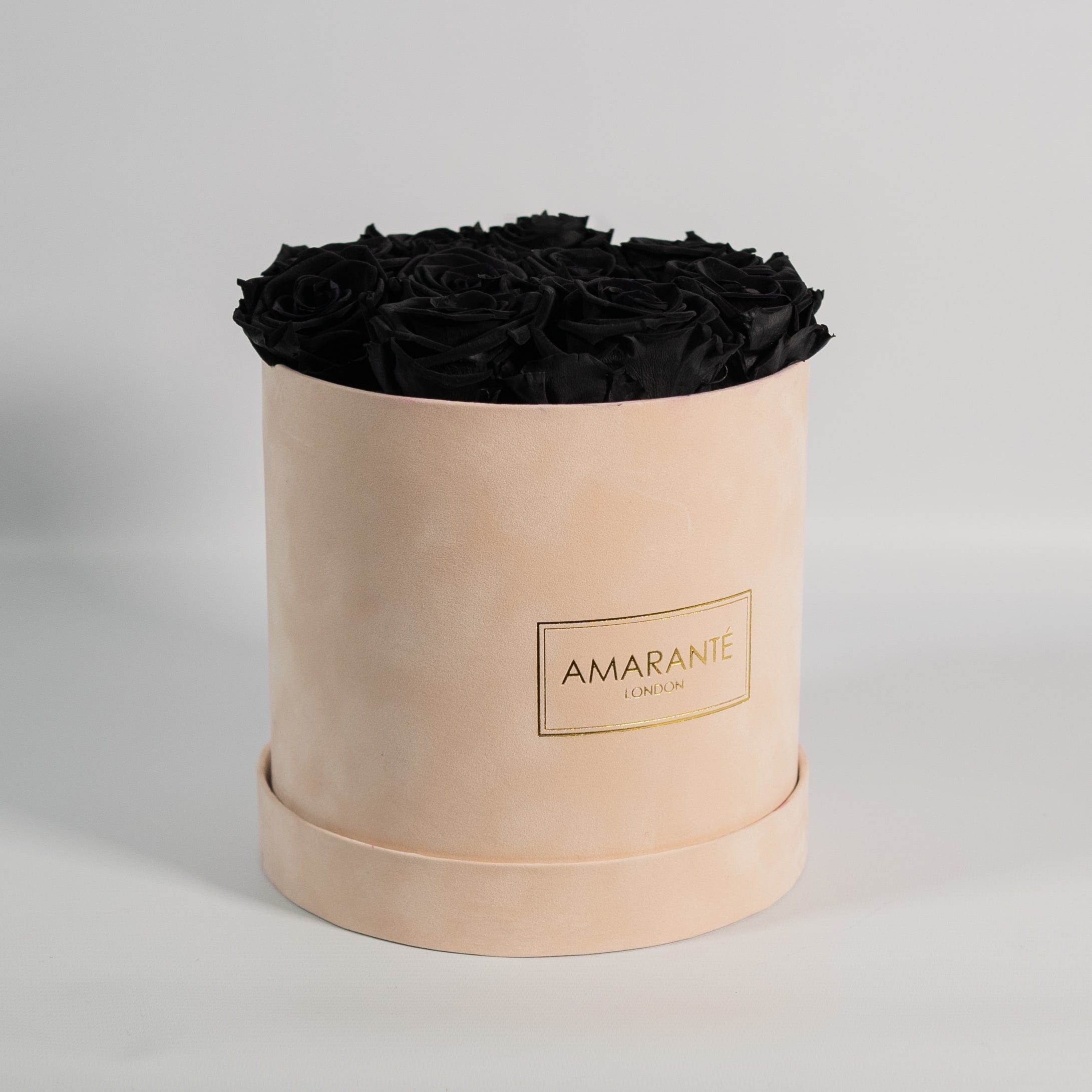 Exotic black roses in a luxurious beige box in suede. 