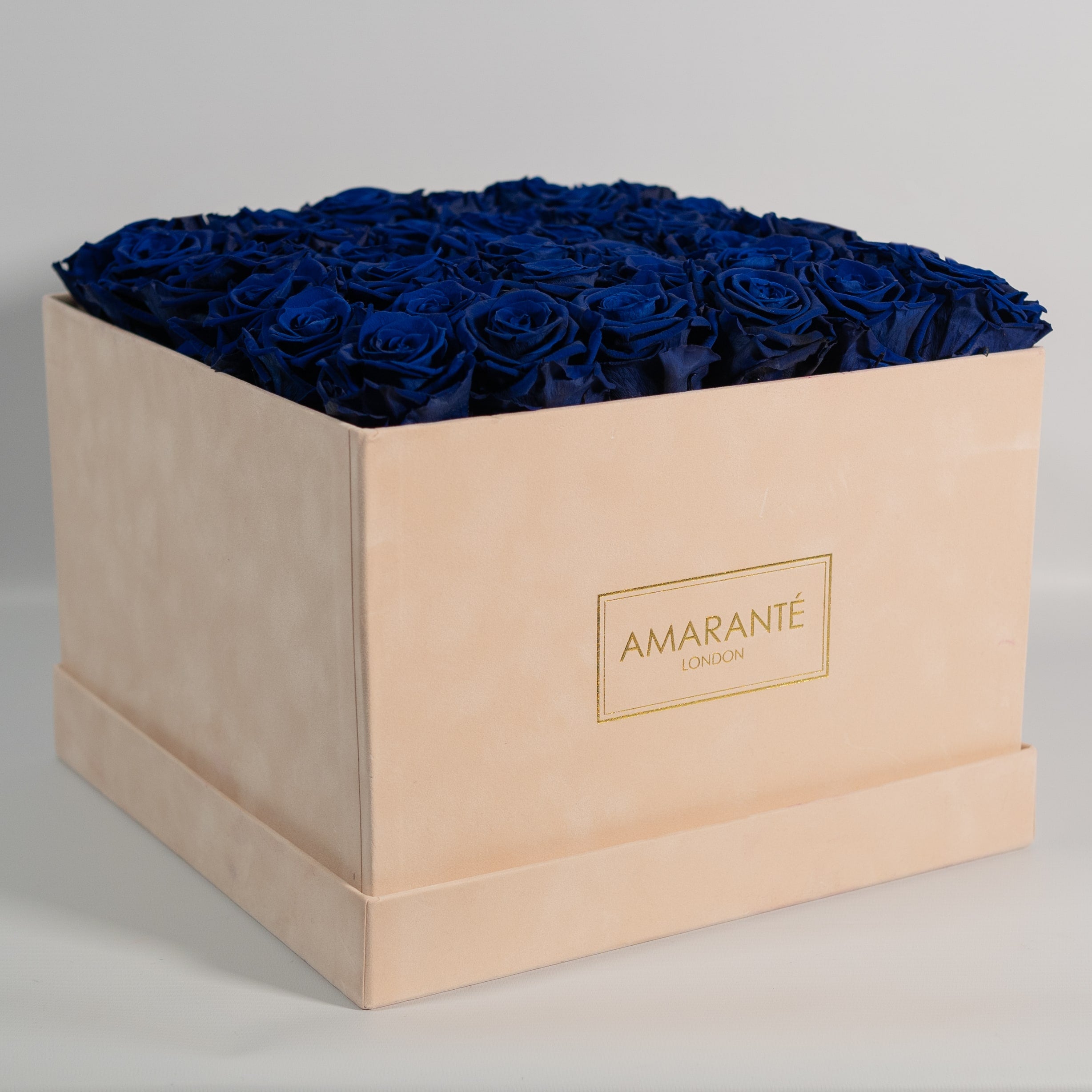 Luxurious royal blue Roses in an extra large beige box.
