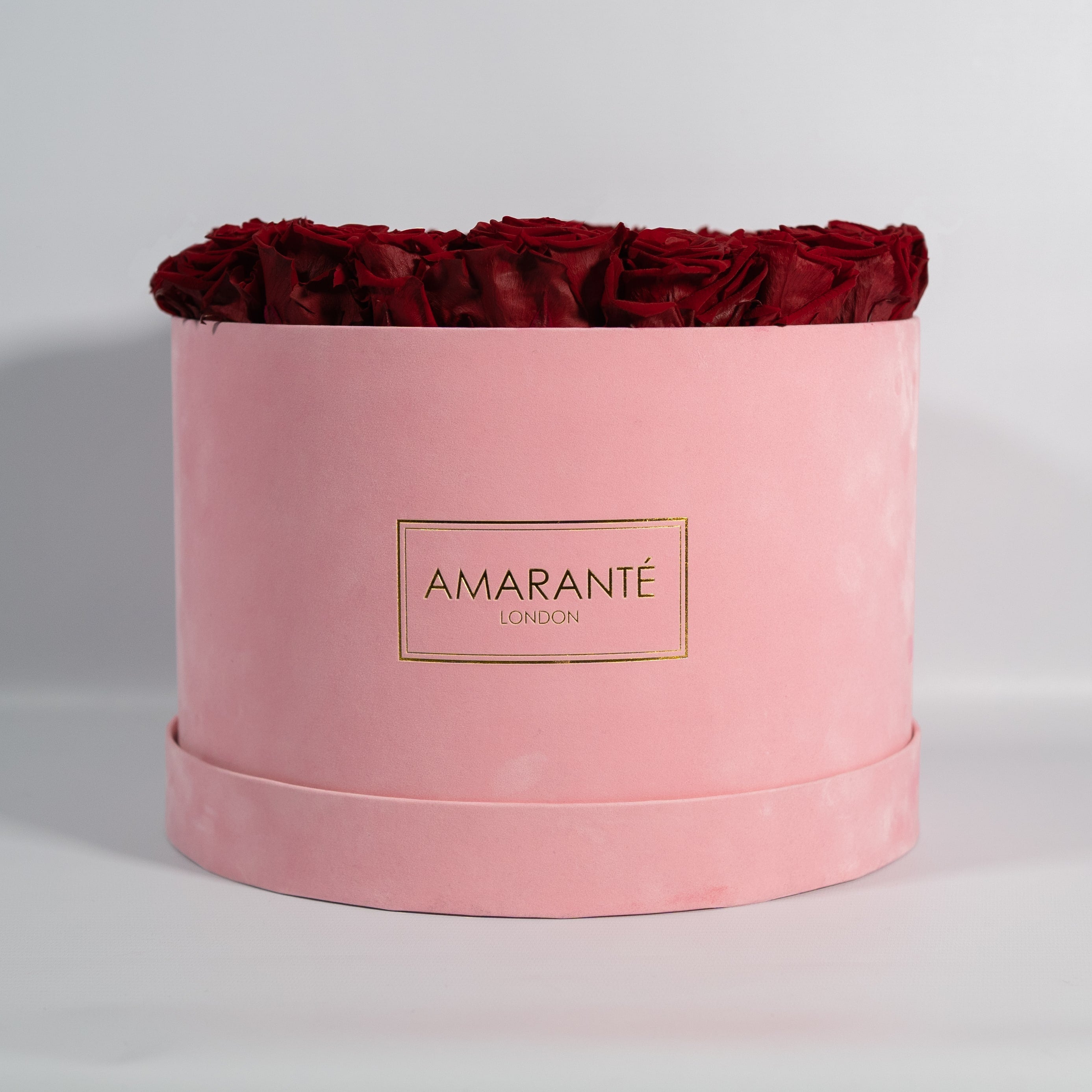 Dreamy dark red Roses in  a stunning pink suede box.
