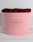 Dreamy dark red Roses in  a stunning pink suede box.