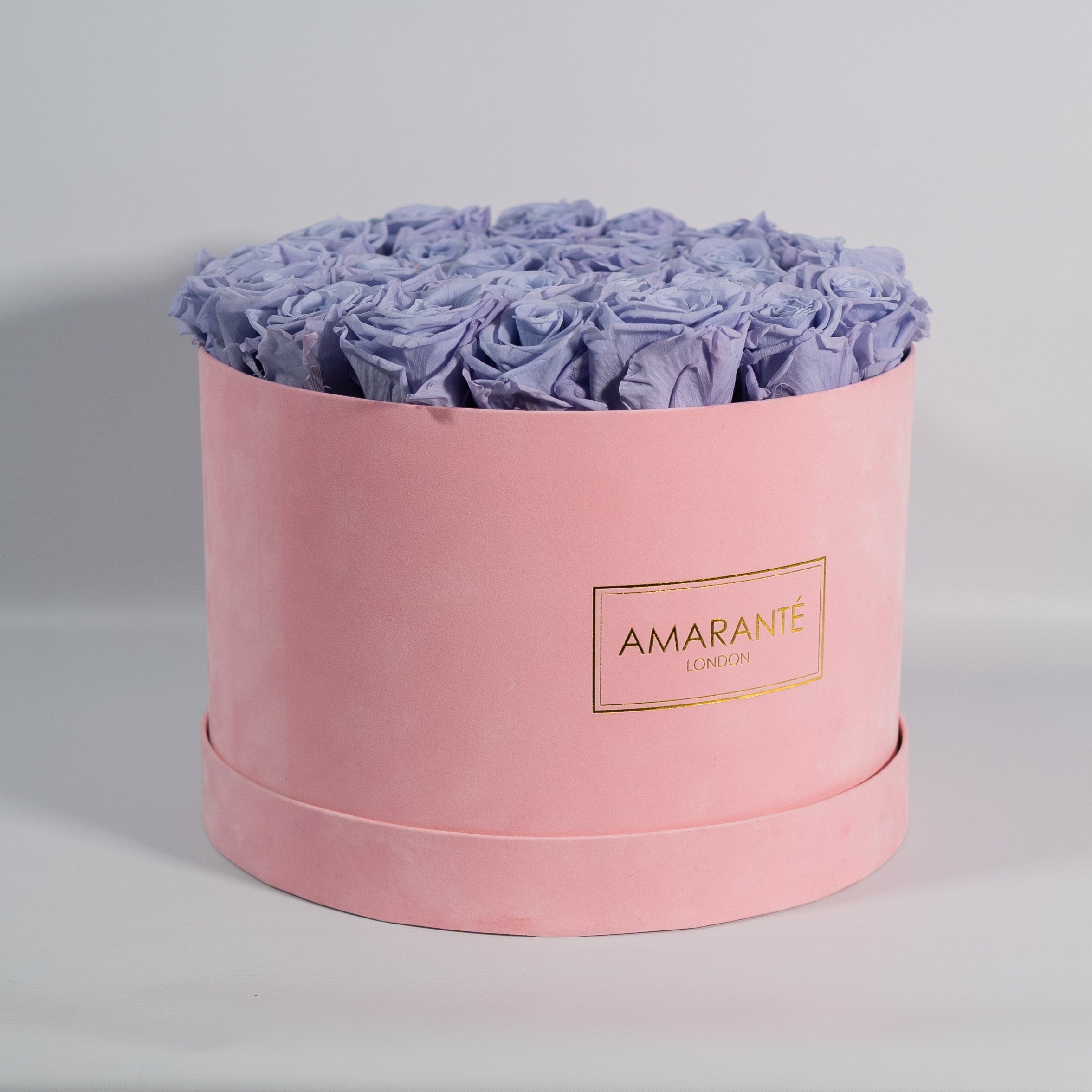 Tranquilising  Lavender Roses imbedded in a sophisticated pink box 