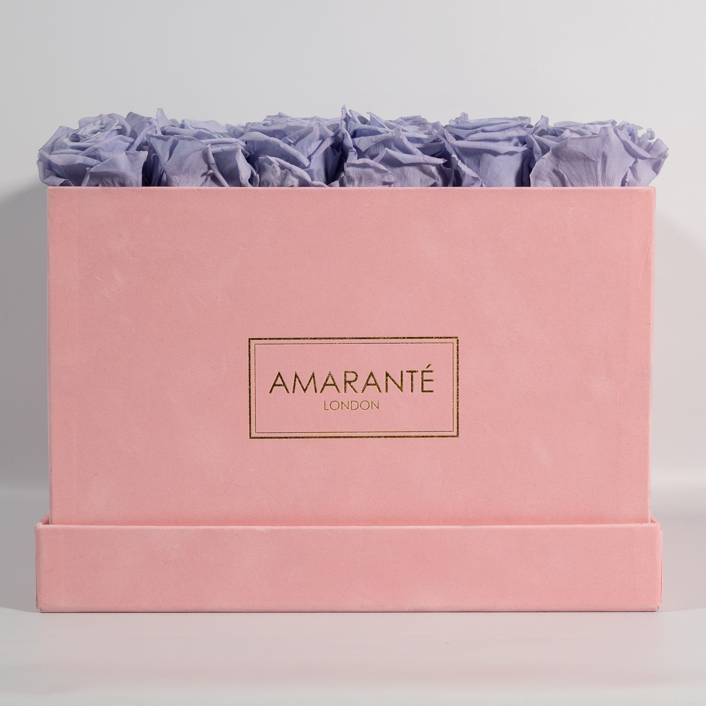 Artful lavender roses featured in a magical pink box 