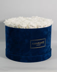 Gorgeous white roses in a contemporary blue box in circular shape.