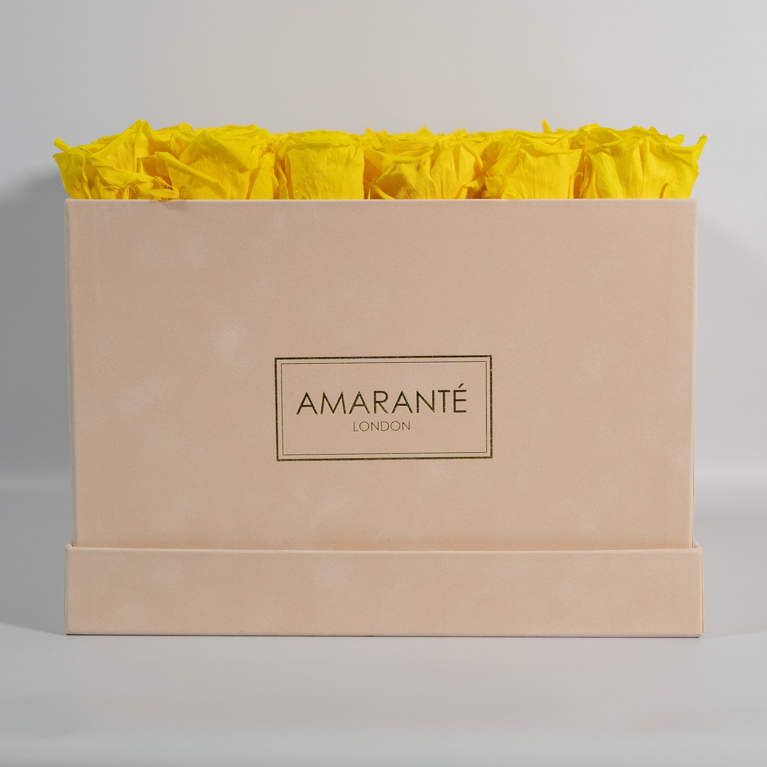 Delightful yellow Roses in a blushing beige box.