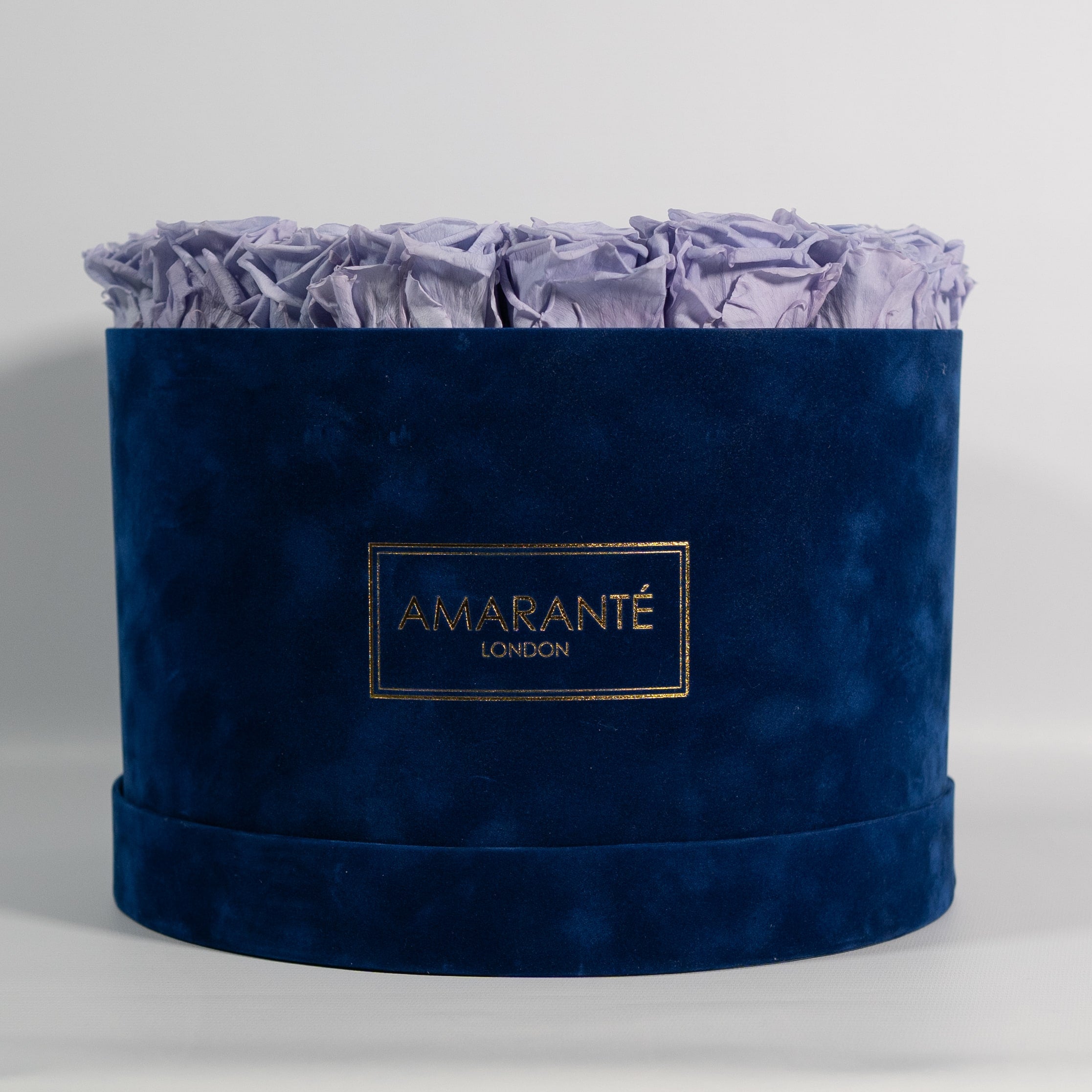 Tranquillising lavender roses photographed in a dapper blue box. 