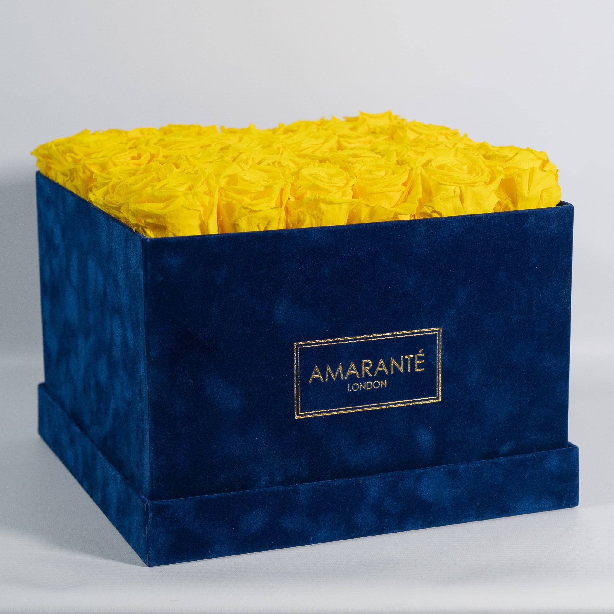 Delightful Yellow Roses in a fashionable blue package.